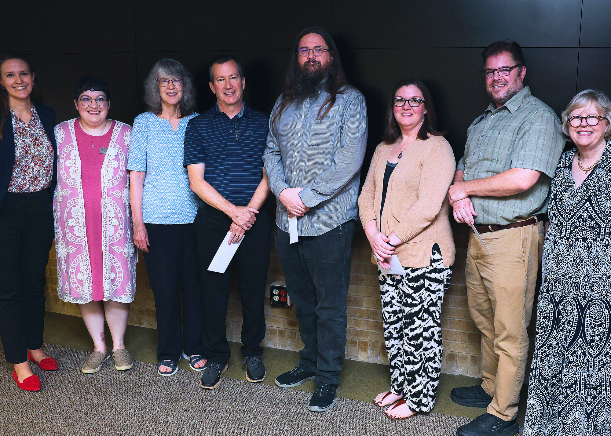 Longevity service award winners standing between the University Librarian and a representative from the Friends of the Texas A&M University Libraries.